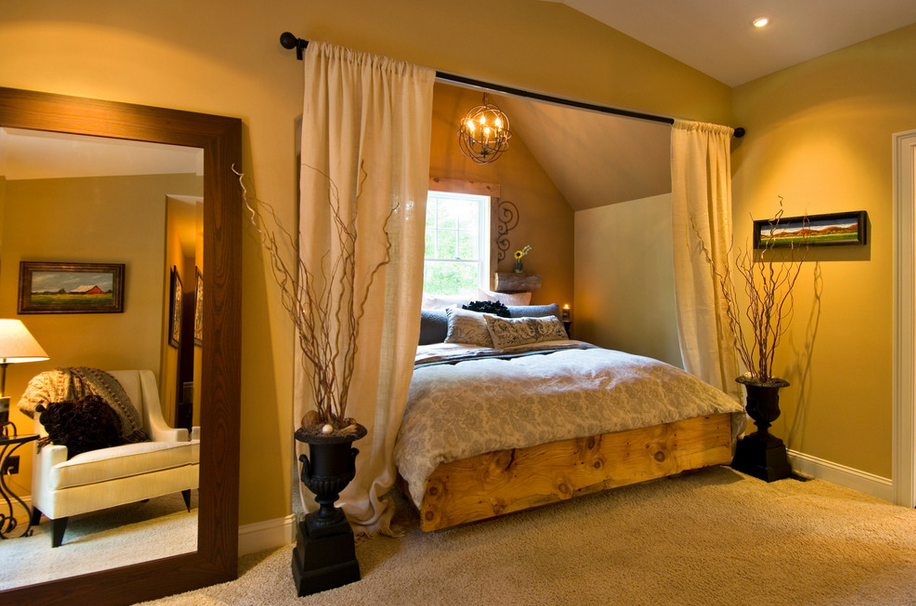 Eclectic bedroom featuring an oversized mirror and an alcove bed