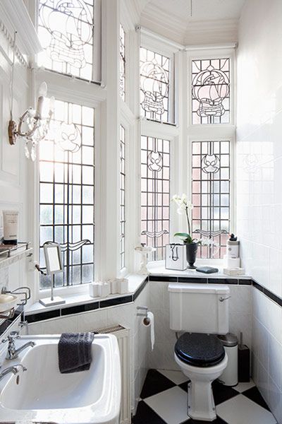 Light-filled black and white bath, gorgeous windows.