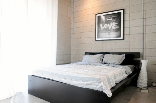 White bed linen black bedframe