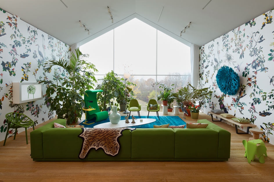 Green sofa white blue living room patterened wallpaper
