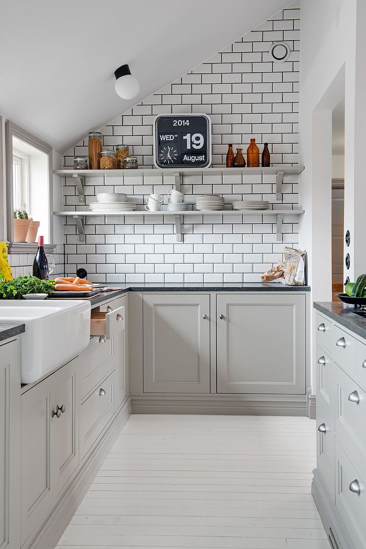 gray cabinets, white subway tile with dark grout, open shelves