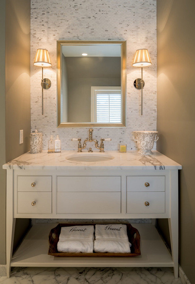A custom made vanity painted in a crisp white paint is perfectly paired with a marble countertop