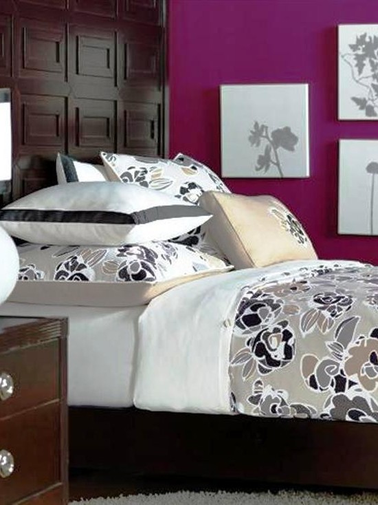 Modern graphic flowers spread over the champagne colored duvet cover while a wide ribbon finishes the crisp white bed skirt