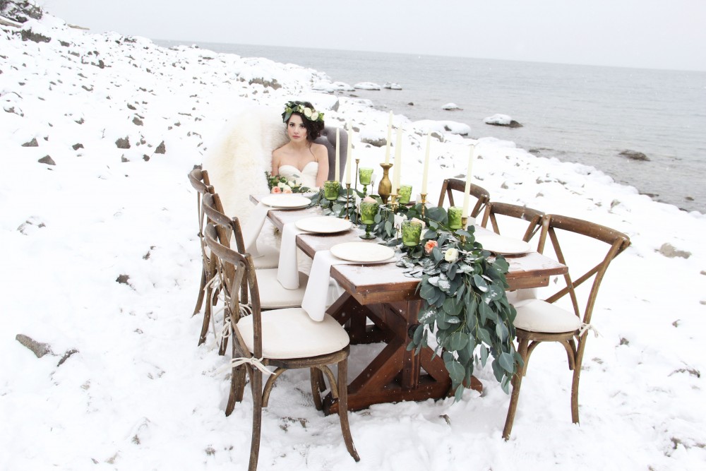 The frosty lake shores and snowcapped pine trees make a lovely backdrop for wintery bridal portraits.
