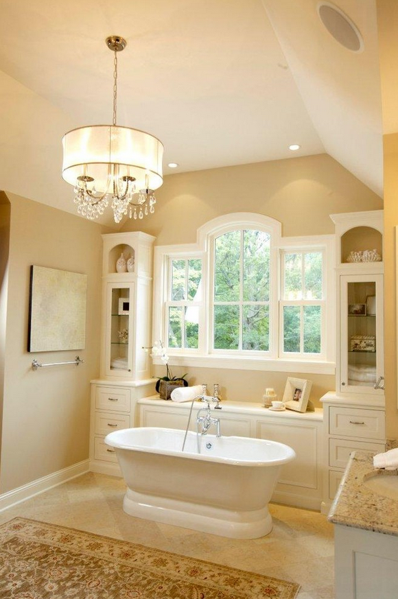 traditional bathroom in Miami with a freestanding tub and Beautiful window, surrounded by cabinets