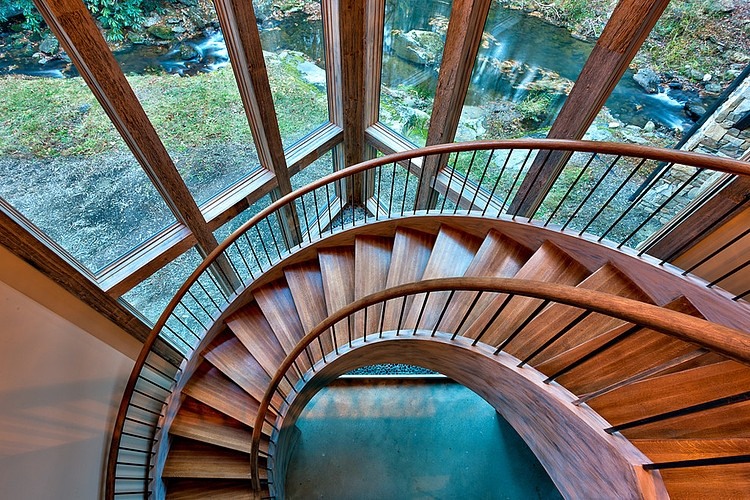 Beautiful sweeping stairs encased in glass surround