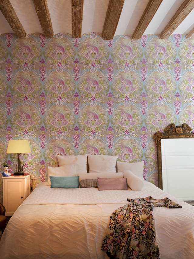 Bedroom with an artistic wallpaper design