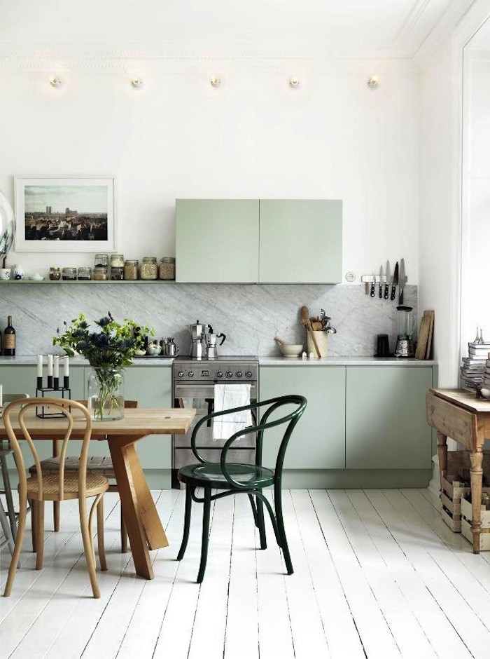 Kitchen of Scandinavian stylist with mint green cabinets and a marble countertop