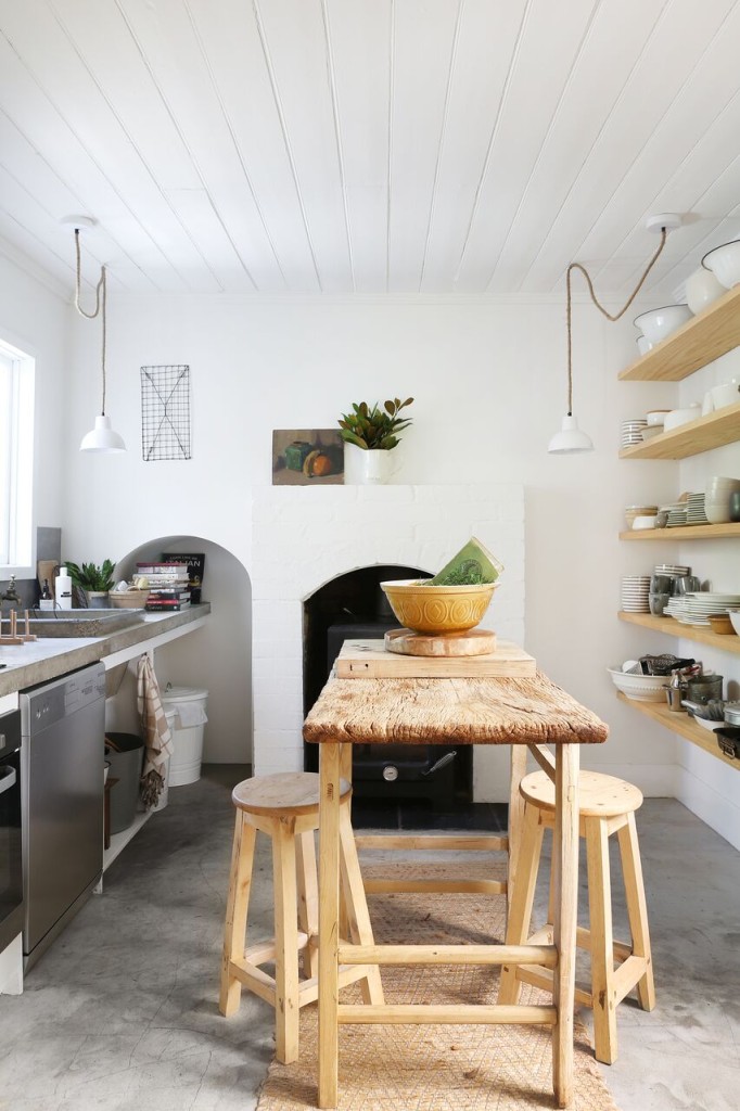 narrow rough hewn vintage table anchors the kitchen