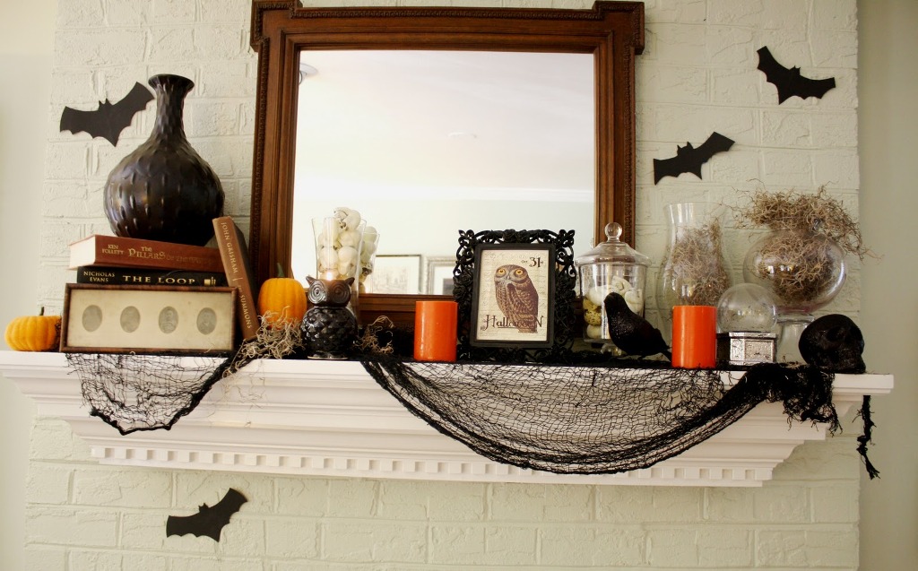 Spooky Halloween Wonderful mantel design with small black owl statue and elegant bats wall decor