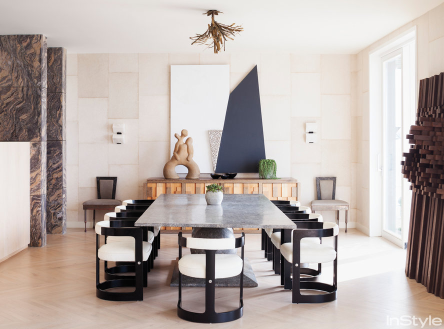 The sunken dining room stone table and modern chairs