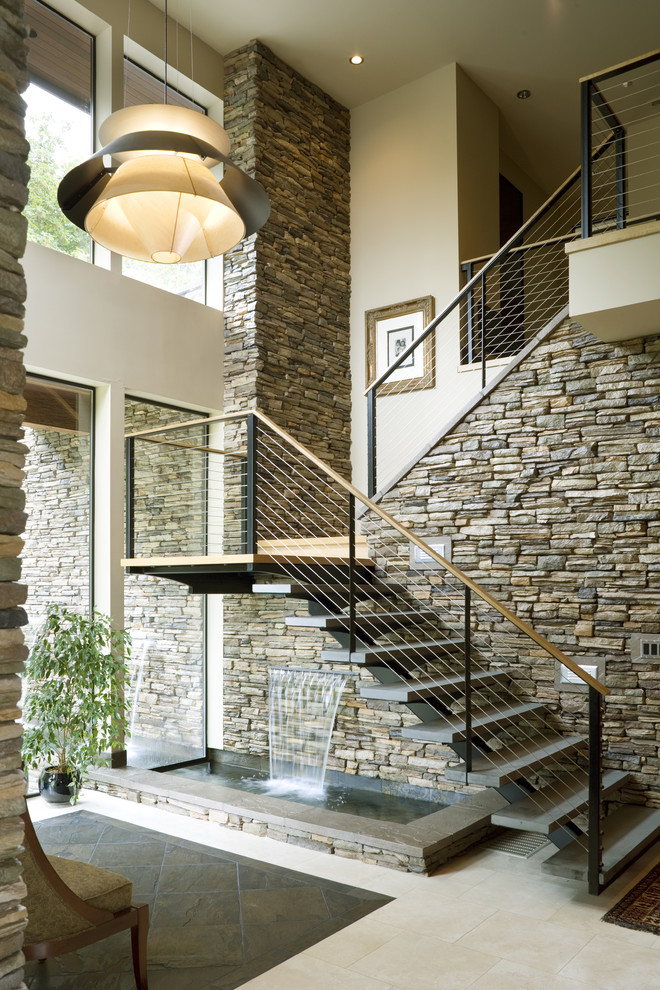 Trendy open staircase with stone wall
