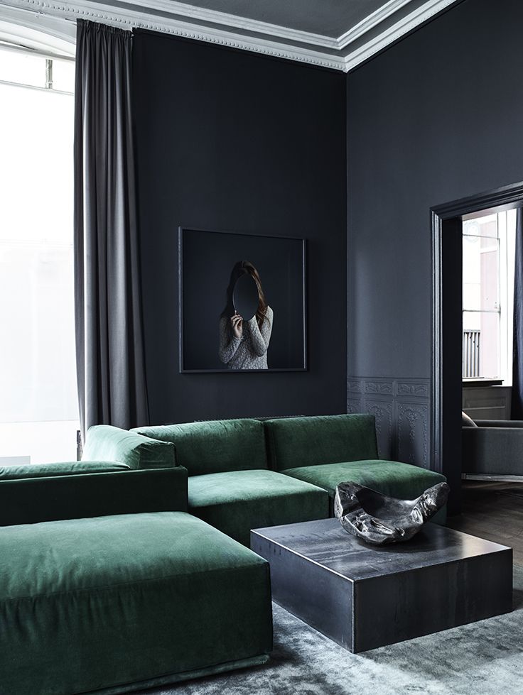 living room dark walls and deep green velvet sofa