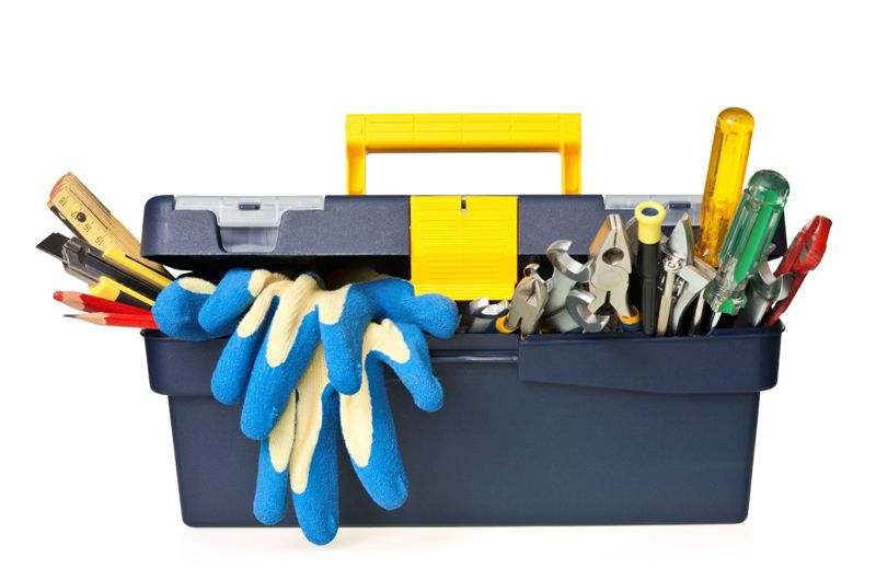 plastic workbox with assorted tools on white background