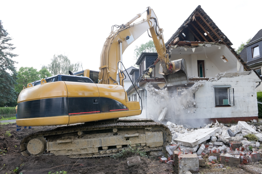 Digger demolishing house