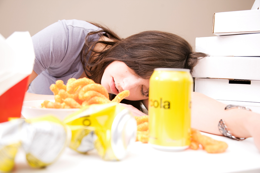 Woman sleeping after eating a lot of food