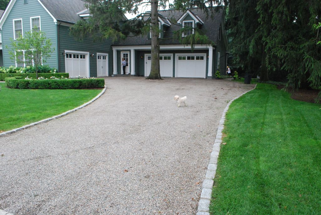 Outline the edge of the driveway