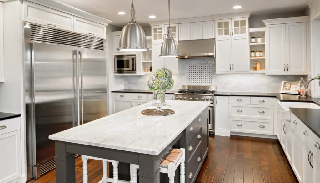 Beautiful Kitchen in Luxury Home with Island and Stainless Steel Refrigerator