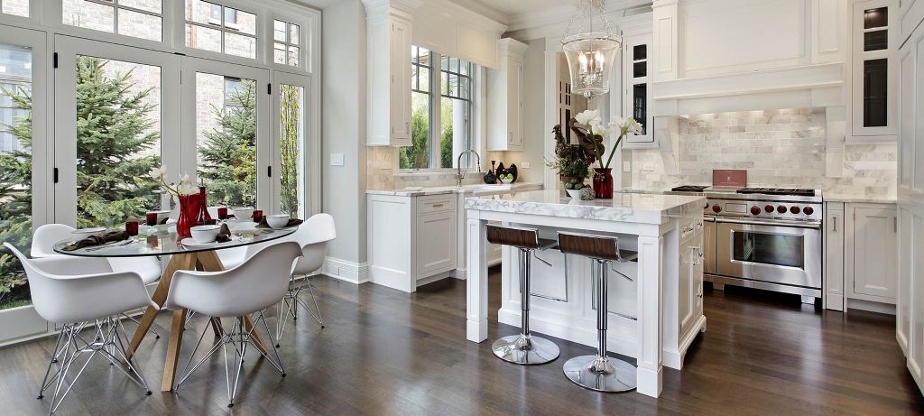 Kitchen in luxury home with white cabinetry.