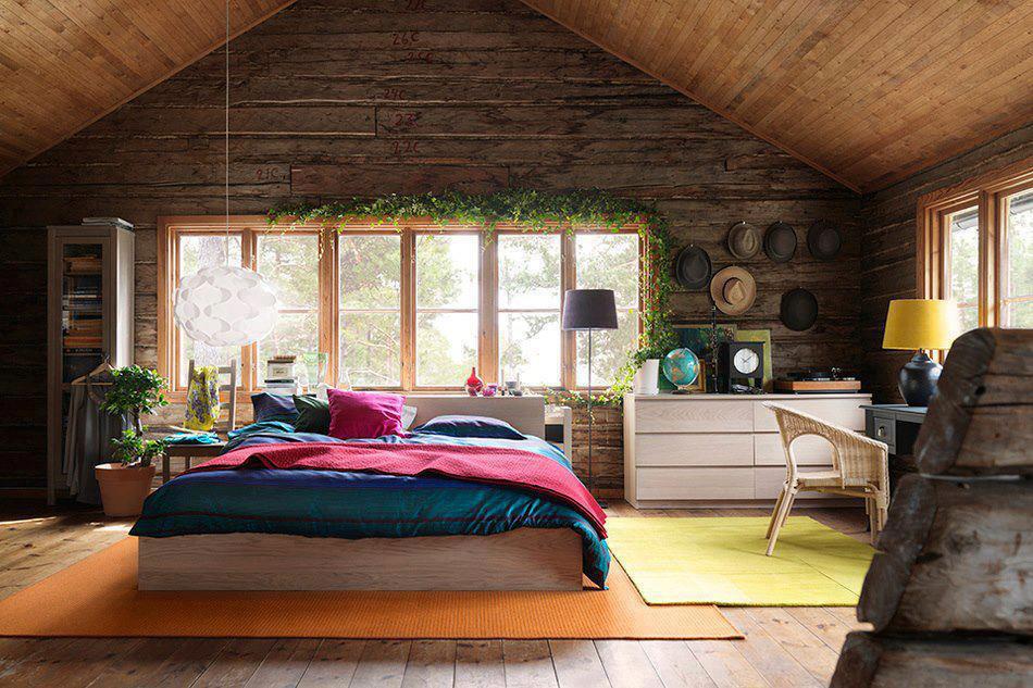 Interior, bedroom in modern wooden house, green vines on wall, colorful quilt on bed, dazzling amazing modern house