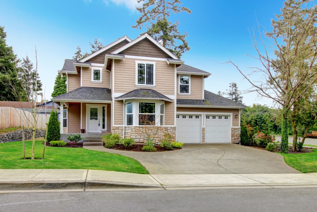 Beautiful beige siding house with stoned base